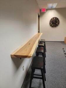 a side profile of a short custom bar top with stools