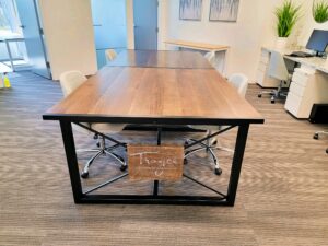 custom wood conference table with black metal trim and legs