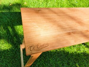 custom wood table with Ol'Charm engraved into it