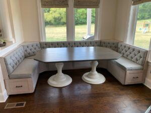 custom made dark wood breakfast table with white legs and booth