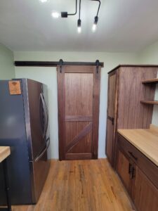 custom sliding barn door that leads into and out of kitchen