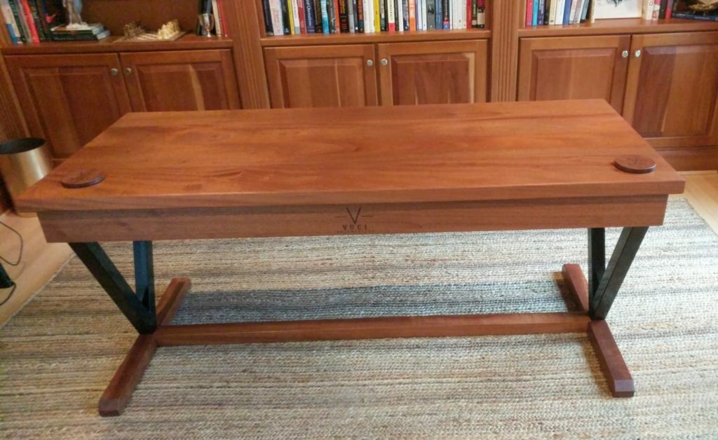 wood desk on top of a rug inside of an office