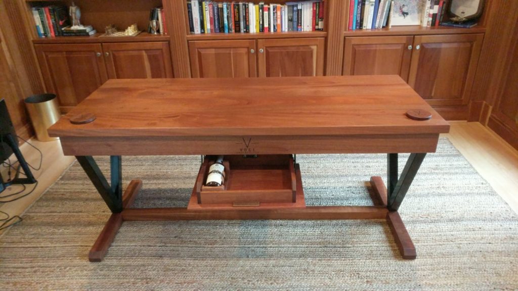 a custom desk with a pull out drawer for alcohol
