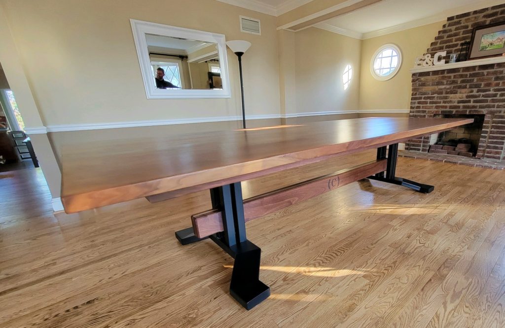 very large custom table with wooden legs and a wooden crossbar for support