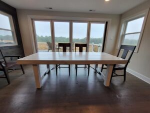custom white wood dining table with dark brown chairs