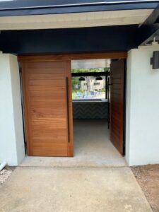 chestnut colored wood doors with black handles